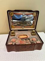 vanity box open showing mirror, bottles, compartments