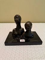 Front view of bronze mother & child busts on marble base