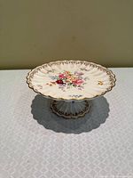 Top view showing floral centre, scalloped gilt rim