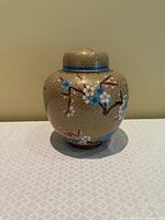 Front view of cloisonné ginger jar with lid showing floral design