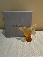Figurine displayed in front of Lalique box
