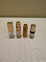 Front view of all four vintage perfume bottles