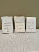 Three sealed Hermès rain protection bag cover packages front view