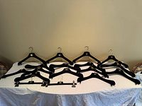 Full set of Chanel velvet hangers arranged on table