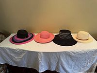 All four hats lined up on table