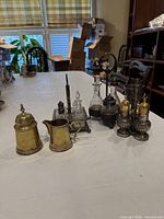 Group shot of all silver-plated condiment pieces on table