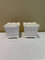 Front view of both white square planters