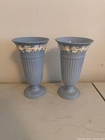 Pair of light blue Wedgwood trumpet vases front view
