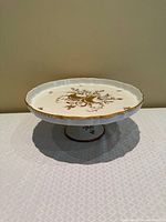 Top view showing gold floral motif, scalloped edge, overall surface