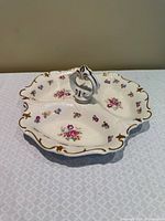Top view showing full dish, floral pattern, gold trim, central handle