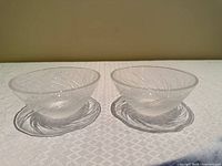 Pair of clear etched glass bowls side by side