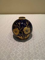 Front view of cobalt blue Limoges vase with gold floral design