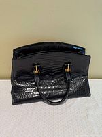 Front view of Suarez black croc-embossed leather handbag
