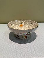 Top view showing interior figural scene, foliate pattern, gilt rim