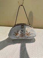 Front view of beaded purse showing floral design and handle