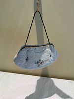 Front view of beaded purse hanging by handle
