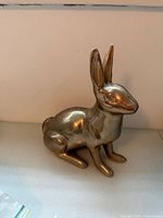 Front left view of brass rabbit doorstop