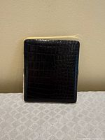 Front view of cigarette case showing crocodile-pattern exterior