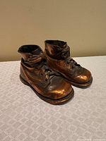 Left side view of copper-plated baby shoe pair