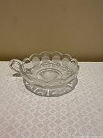 Top view showing scalloped rim, coin motifs, starburst center