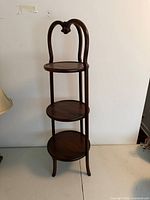 Full view of wooden three-tier stand front