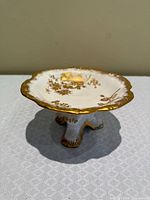 Top view of Hammersley pedestal dish showing gilt floral pattern and scalloped rim
