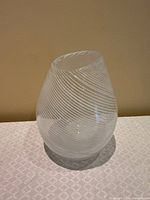 Front view of clear vase with white spiral filigrana and angled mouth