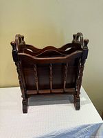 Front view of wooden magazine rack showing overall design and condition