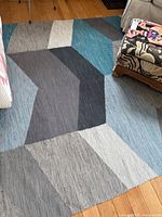 Full view of geometric cotton rug on hardwood floor
