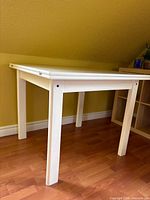 Full view of table unfolded showing square top and legs