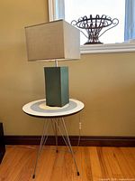 Lamp on tripod side table showing full view with shade and base