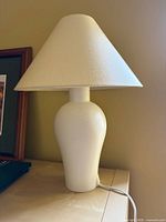 Lamp on tabletop showing full view with shade