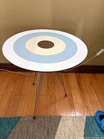 Top view of table showing concentric circle design and hairpin legs