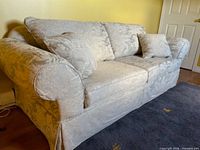 front view of light beige damask sofa bed