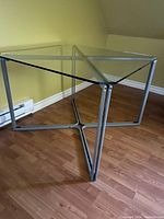 Full view of square glass top table on metal frame