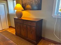 Front view of cedar cabinet with lamp on top