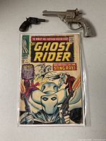 Comic book bagged with two toy cap guns