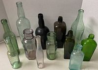 Front view showing all 12 bottles in assorted colours and shapes