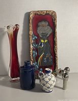 All five items grouped: wall plaque, glass vase, two small vases, chrome candle holder