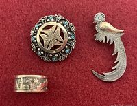 Front view of three jewellery pieces on red background