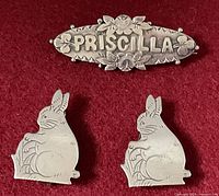 Front view of sterling Priscilla brooch and two rabbit sweater guard clips