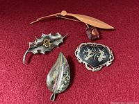 Front view of all four brooches
