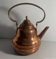 Front view of copper pot showing handle, lid, spout and overall shape