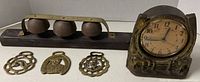 all items: three-bell sleigh bell bar, three brass horse brasses, horse-themed electric clock