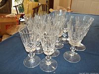 Group of 13 cut crystal stemmed glasses on table