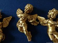 Close view of gold plaster cherub ornament with violin