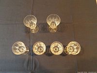 Top view of six cut crystal glasses showing pattern and arrangement