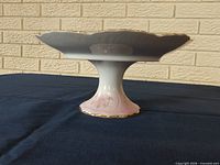 Side profile showing pedestal and scalloped tray