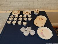 Entire lot overview showing ramekins, casserole with lid, tart dish, two trays, glass ramekins, teapot