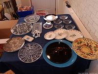 Full lot overview on blue tablecloth showing all plates and trays